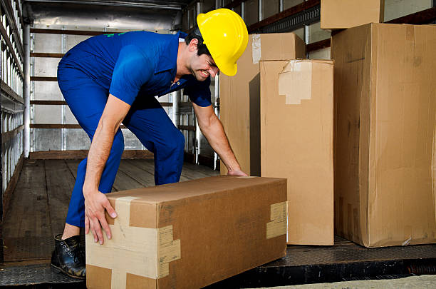 Mover Lifting a Box Incorrectly stock photo