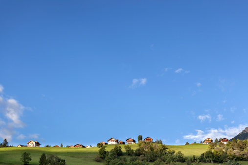Blue sky over mountain village - large copy space