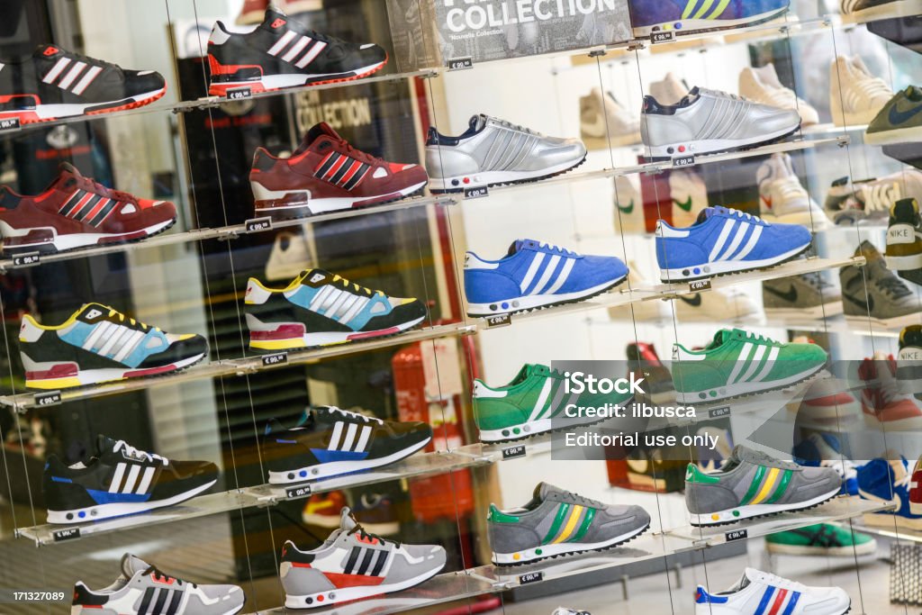 Several Adidas Shoes In Foot Locker Store Window Stock Photo