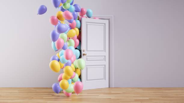istock 3d render. Abstract party background. Multicolored air balloons and inflatable balls fly out the open door inside the empty room 1713271084