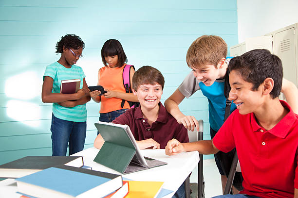 istock Teenage boys using digital tablet at school. Laughing. Friends. 171327166