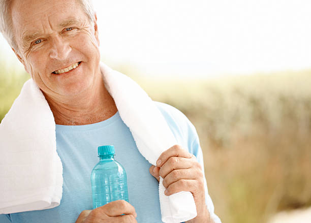 istock A man with a towel on his shoulders holding a water bottle 171327317