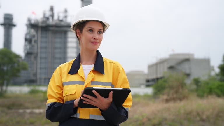 Accomplished female engineer driving force in the world of innovation and market trends. Standing at power plant generator factory. Using laptop serving gateway to a wealth of data. Opportunity guided by Planning and a strong Project Management framework.