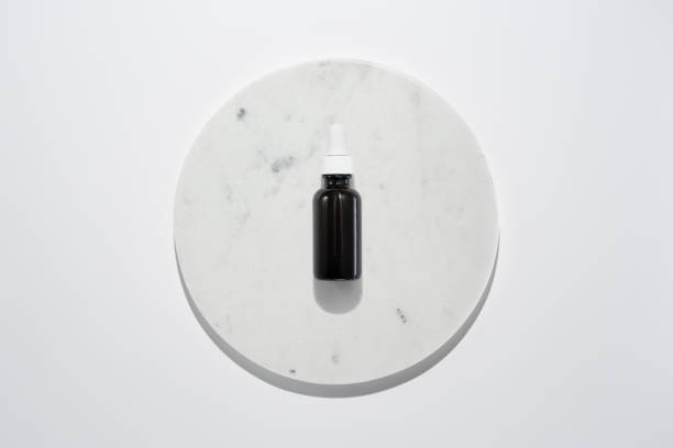 istock Face oil serum on marble circle white background 1713275133