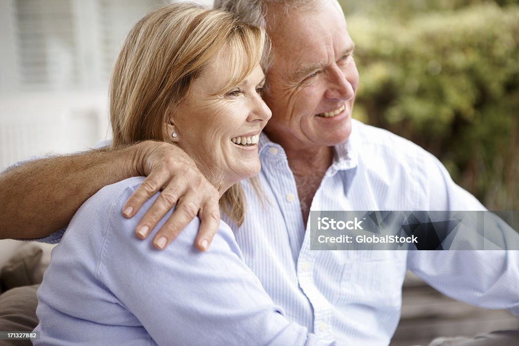 Their hard work has finally paid off with retirement A senior couple sitting outside and thinking Looking Stock Photo