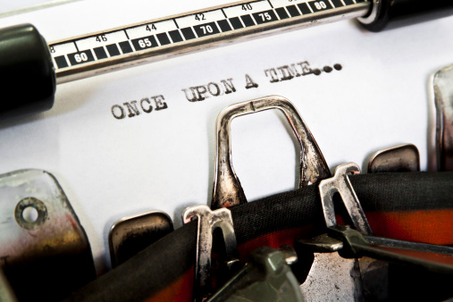 The words 'Once Upon A Time...' picked out on a grungy old typewriter.