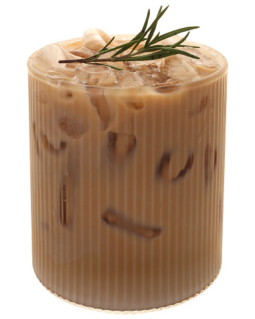 Iced latte in modern glass decorated with a sprig of rosemary and peach on top