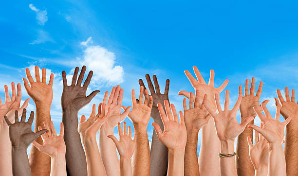 istock Mixed nationality hands waving toward camera with blue sky 171328450