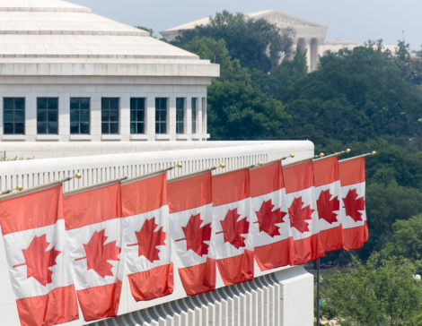 Canadian flags fly outside of the embassy in Washington DC.