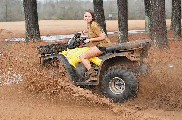 istock Girl spinning out atv in muddy field 171328882