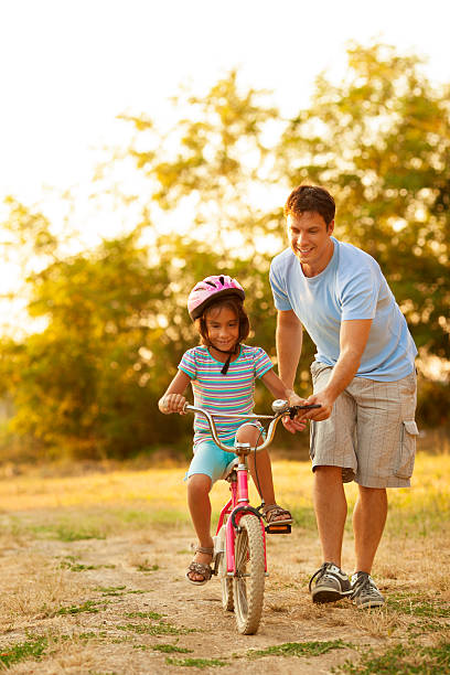 istock Father Teaching Child to ride a bicycle. 171328975