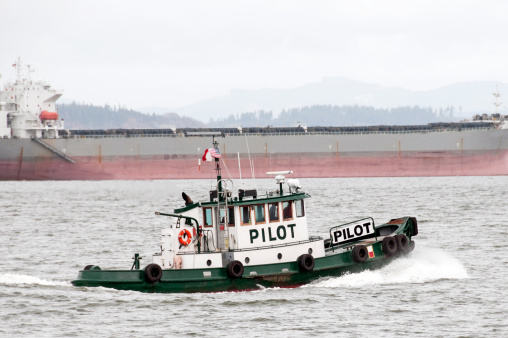 Pilot boat and freighter on Columbia River in Oregon