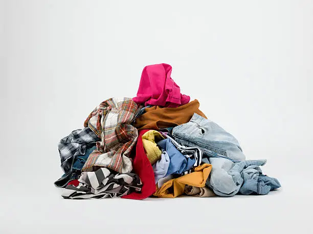 Piles of dirty-clean clothes on white background