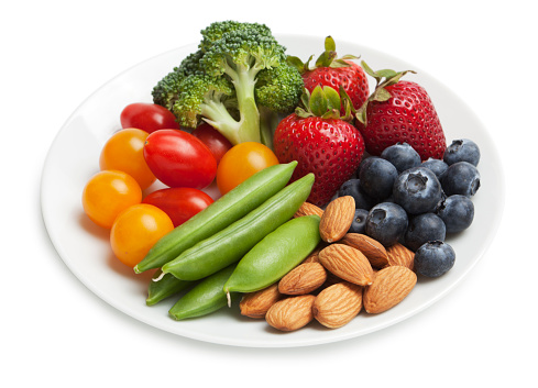 Healthy snack plate with fruit, vegetables and nuts