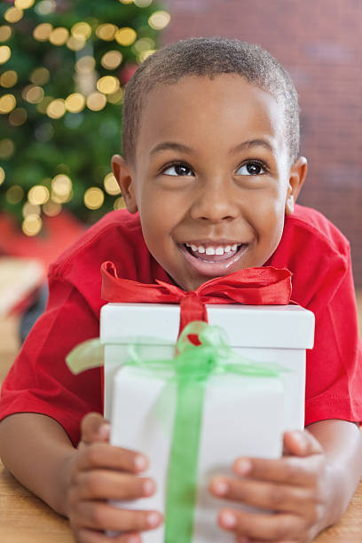 istock Cute little boy holding present on Christmas morning 171329513