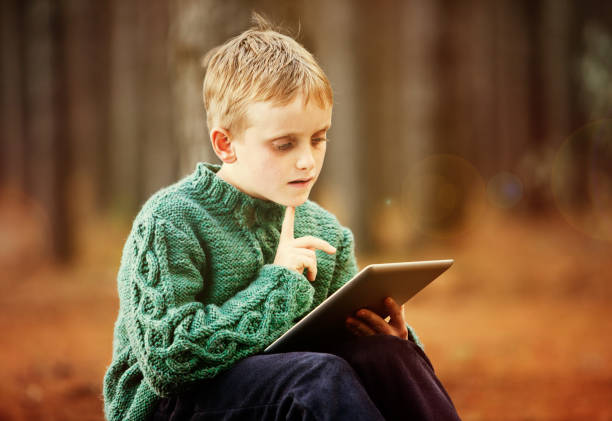 istock Little blond boy fascinated by tablet-style computer 171329944