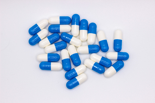 Blue and white medicines on a white background.