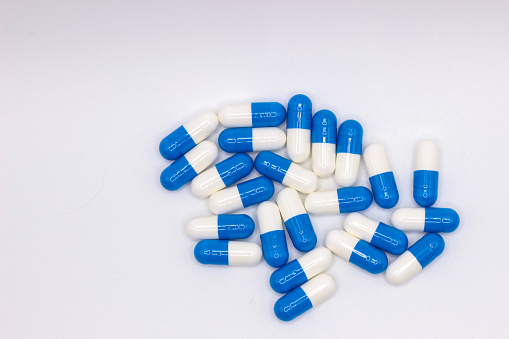 Blue and white medicines on a white background. Healthcare.