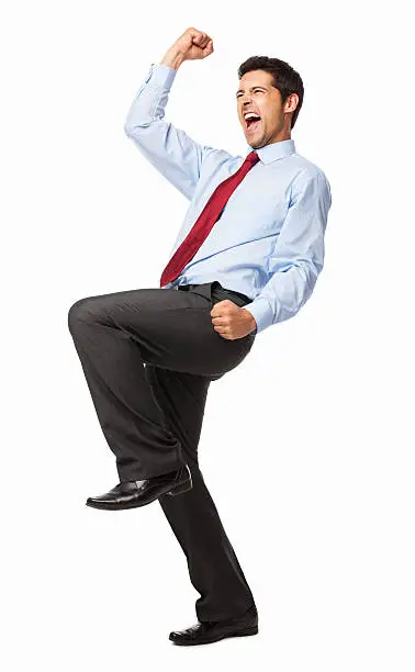 Full length of a happy male executive celebrating success with clenched fists. Vertical shot. Isolated on white.