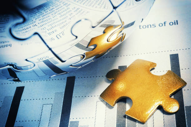 istock Golden jigsaw piece on financial page 171330354