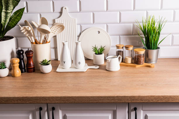 istock White ceramic utensils and kitchen utensils on a wooden countertop in an eco-friendly kitchen with green indoor plants. Cozy house 1713305367