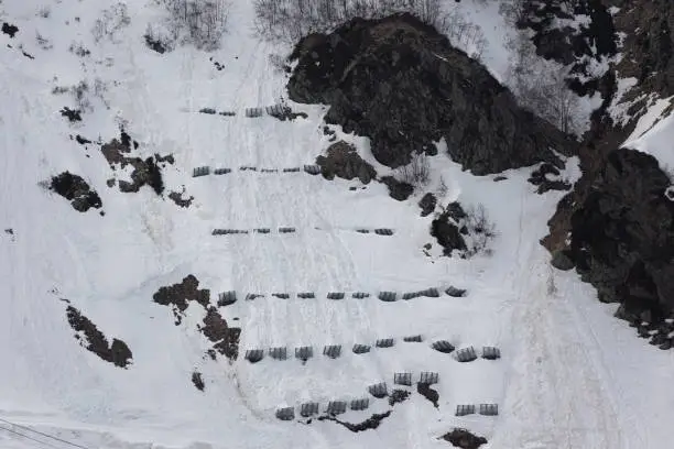 An avalanche snow barriers on ski-resort at Sochi, Russia. Mountain slope with avalanche prevention walls. Avalanche control activities reduce the hazard avalanches pose to human life, property