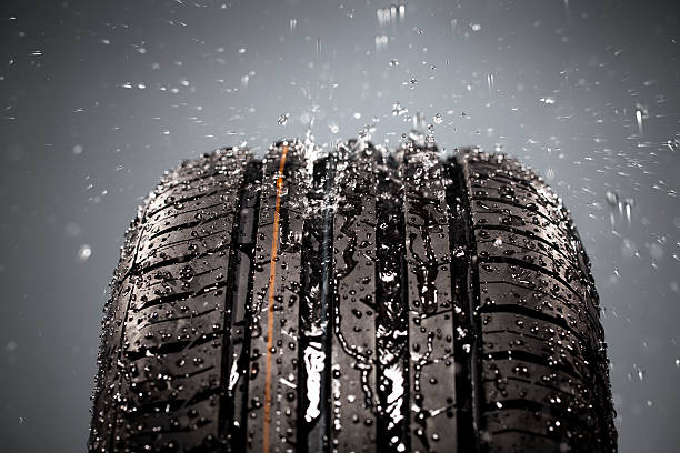 istock New wet tire with a gray background 171330557