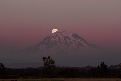 Mt. Rainier at dusk. A full moon.