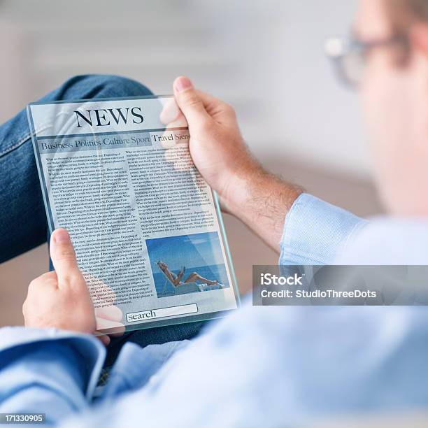 Foto de Homem Lendo Notícias Com Digital Tablet A Futurística e mais fotos de stock de Jornal