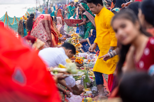 Ghaziabad, Uttar Pradesh, India - October 2022: Chhath Puja,Indian devotees gathered at fair ground to perform the rituals of chhath puja along with their family.