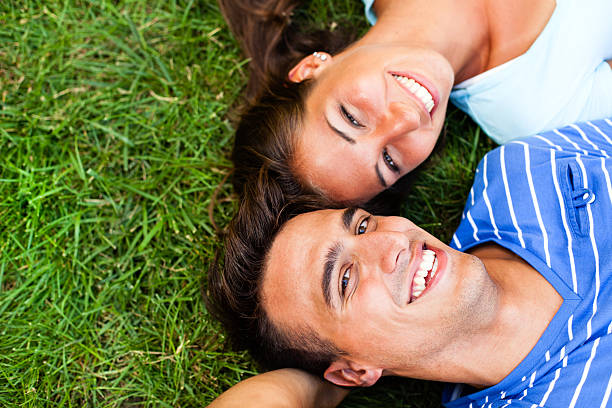 istock Young couple lying down on the grass 171331666