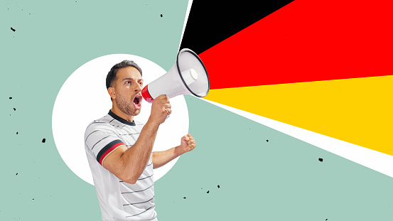 soccer fan with megaphone in hand celebrating on isolated background