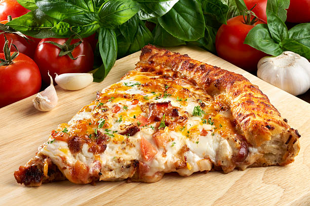 Barbecue Chicken with Bacon PIzza "Pizza made with smokey bacon, cubed chicken breast, chopped tomatoes, onions, tangy Buffalo barbecue sauce, drizzle of ranch dressing and topped with Cheddar and Montery Jack cheese baked on a pre-package pizza dough.See other pizza slices in my Sandwich/PizzaSnacks Lightbox." convenience food photos stock pictures, royalty-free photos & images
