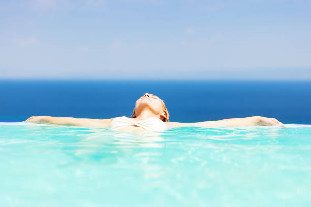 istock Woman relaxing in infinity pool 171332246