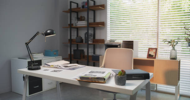 istock Wide Shot of an Empty Desk in Modern Creative Workspace Lit by Natural Soft Morning Light. Comfortable and Well Decorated Home Office. Interior Decor Ideas and Inspiration 1713322526