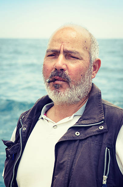 istock senior fisherman smoking cigar 171332482