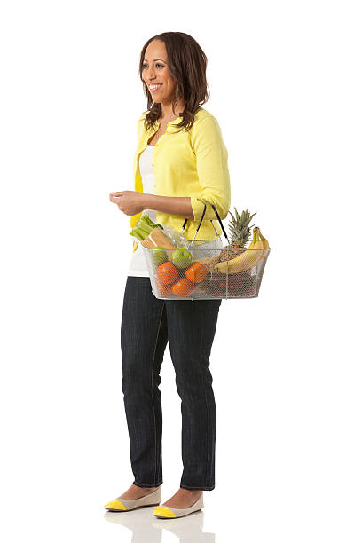 donna felice con un cesto di frutta - men banana holding cut out foto e immagini stock