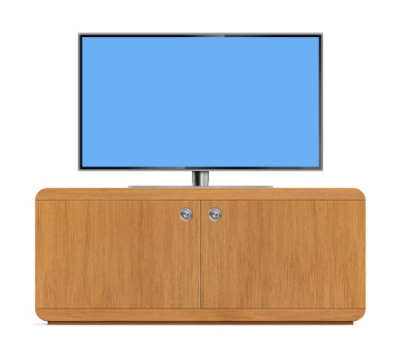 Front view of high-definition flat screen LCD television on a wooden cabinet. TV has a metallic frame and stand with blank blue screen. Clean image and isolated on white background.