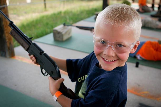 Shooting bb gun at camp stock photo