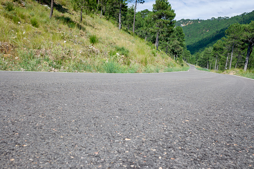 Detail of a steep mountain road, seen from the asphalt.