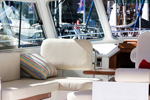 Interior of luxury motorboat with white leather lounge and pilow stock photo