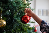 Boy decorating the Christmas tree