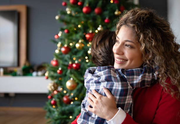 istock Loving mother hugging her son on Christmas Day 1713347444
