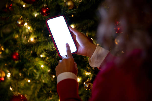 istock Woman using a mobile app next to a Christmas tree 1713347492