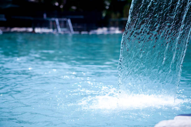 Waterfall in the middle of a swimming pool stock photo