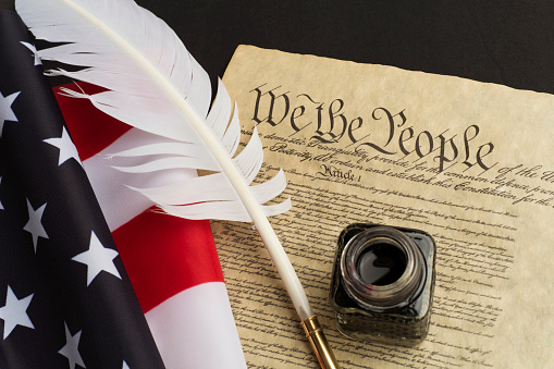 USA Constitution with feather quill pen.