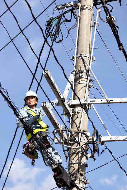 istock Electrician climbing up on telephone pole with pylon 171335043