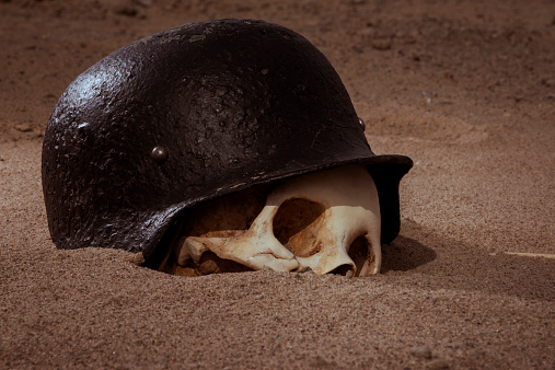 Human skull with German helmet