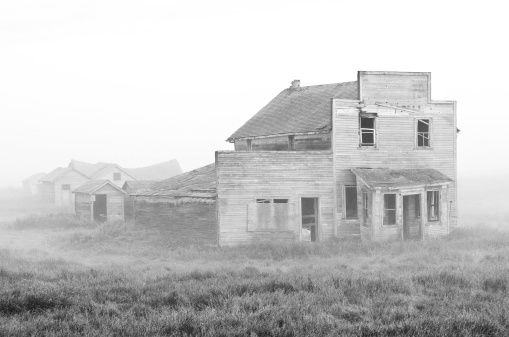 An old abandoned general store on the plains. black and white image.