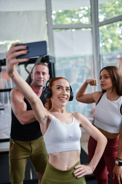 istock Ginger Female Fitness Instructor Taking Selfie With Exercise Group 1713362001